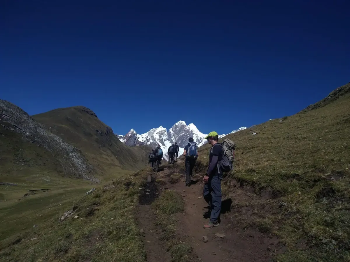 A group of trekkers on the trail in the evening light