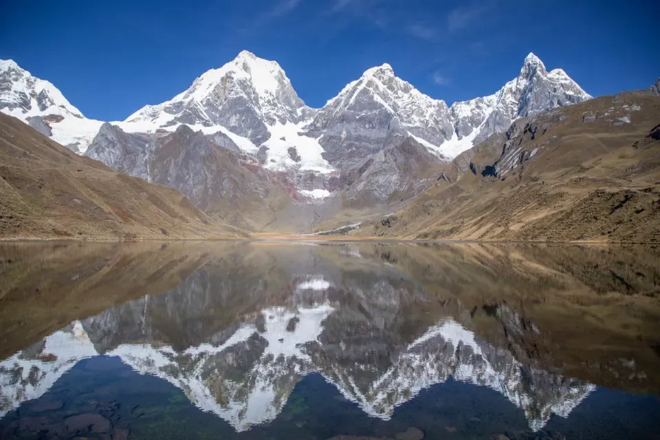 Snow peaks of the Cordillera Huayhuash mirrored in a still laguna
